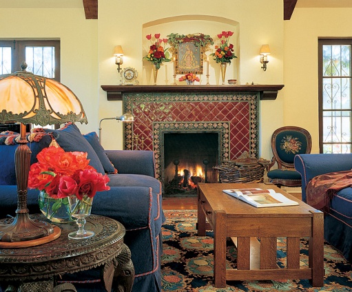 caption: The seating
area of the living room. Ronstadt salvaged the needlepoint chair next to the fireplace
from a sidewalk in San Francisco and wheeled it back to her house. The lamp, which was
purchased in London, rests atop an elephant-motif table from India.