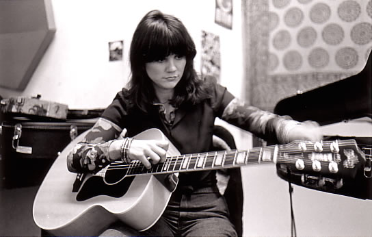 Linda Ronstadt tunes her guitar.